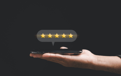 Hand holding smartphone displaying five-star review, symbolizing online reputation management for businesses.