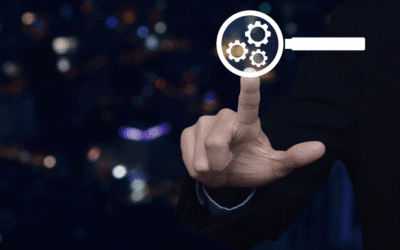 Hand pointing at magnifying glass with gears, symbolizing AI optimizations for digital marketing strategies.