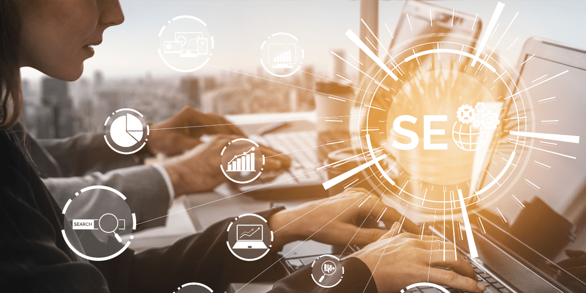 Business professionals typing on laptops with SEO icons and graphs, illustrating digital marketing strategies and zero-click searches.